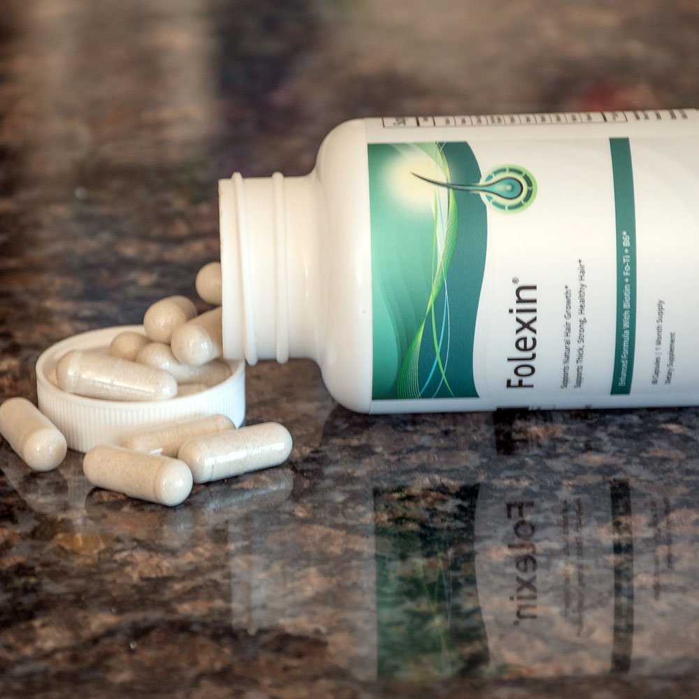 An opened Folexin bottle with pills poured on the table and bottle top